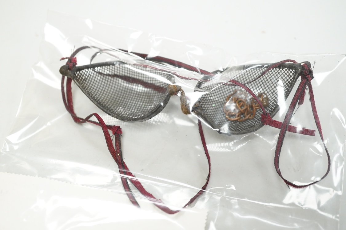 Five pairs of early 20th century goggles with mesh side protectors, two pairs colour tinted, in original tin boxes and two pairs of mesh eye protectors (7)